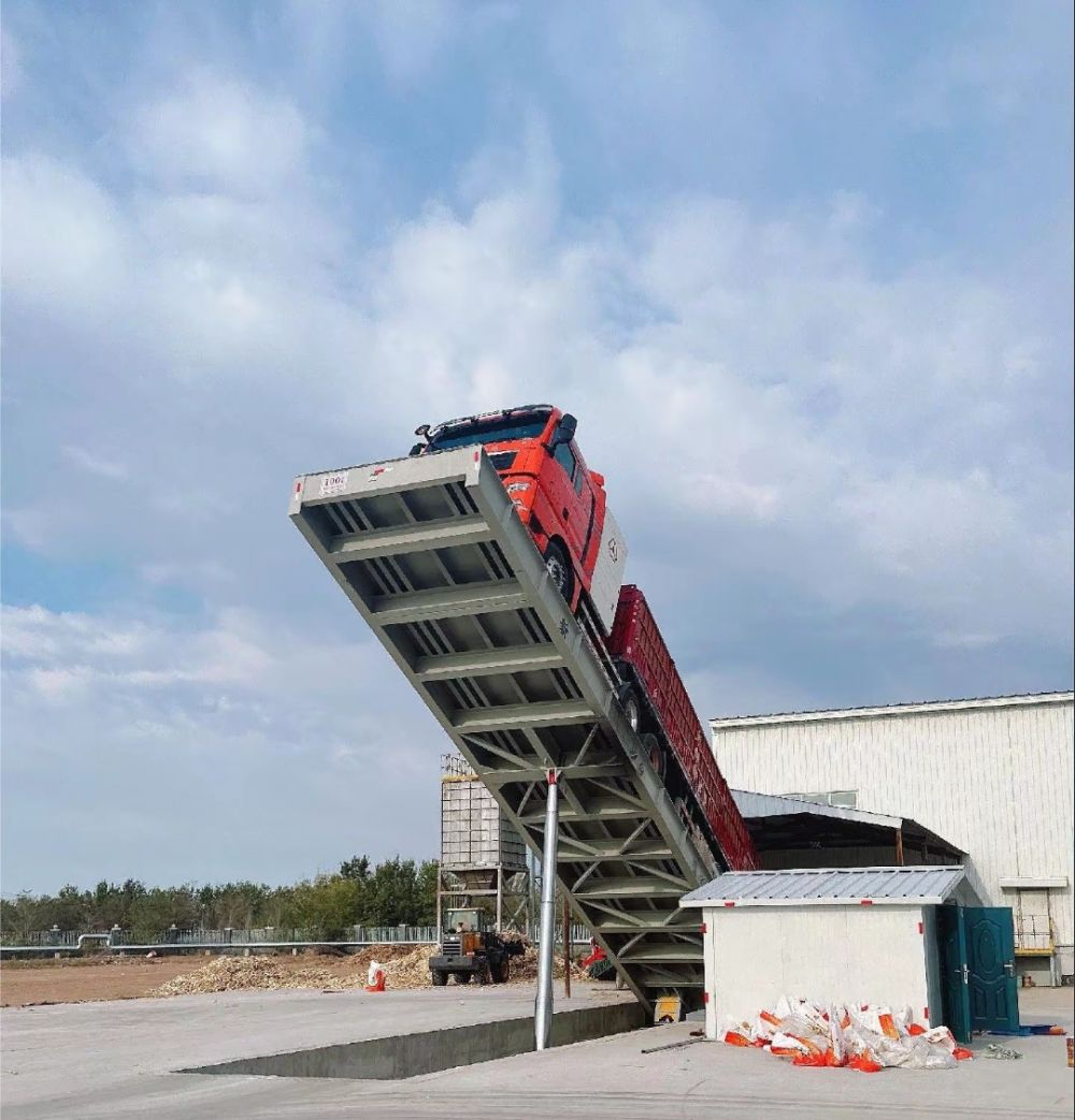 液壓卸車機、后翻式液壓翻板卸車平臺、河南愛信液壓翻板機